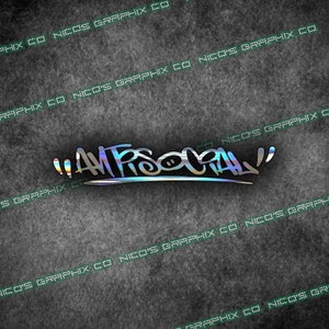 May include: A holographic sticker with the word "ANTISOCIAL" in a stylized font. The text is in a gradient of colors, including blue, green, and yellow, with a silver outline. The sticker is on a textured gray background.