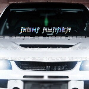 May include: A white car with a black roof and a windshield decal that reads "NIGHT RUNNER" in a holographic, futuristic font. The car's headlights are on, and the text "NICO'S GRAPHICS" is repeated across the bottom of the windshield.