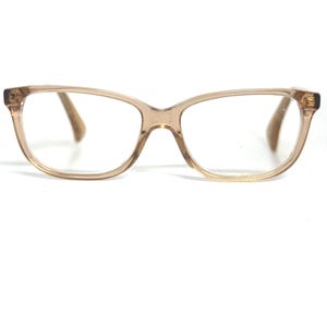 May include: A pair of brown plastic eyeglasses with a rectangular frame.