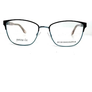 May include: Petite fit eyeglasses with a black and teal frame. The glasses have a cat-eye shape and the brand name BCBGMAXAZRIA is visible on the frame.