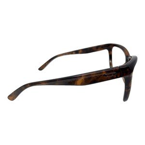 May include: Tortoise shell eyeglasses with a brown frame and clear lenses.