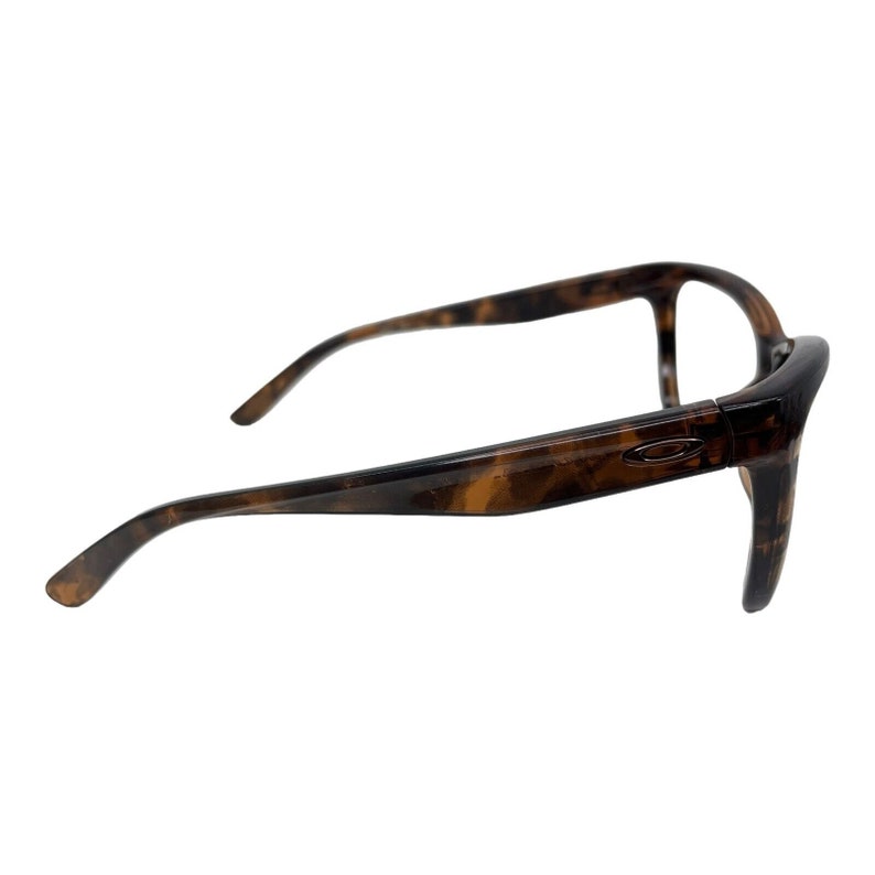 May include: Tortoise shell eyeglasses with a brown frame and clear lenses.