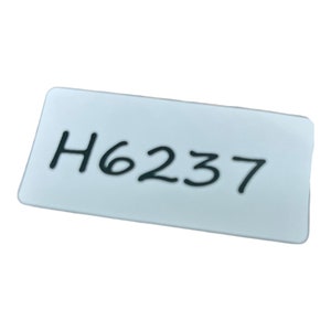 May include: White rectangular label with black handwritten text that reads "H6237".