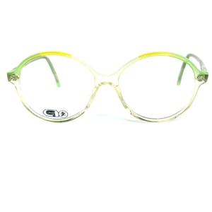 May include: Green and yellow plastic framed spectacles with round lenses.
