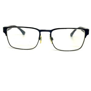 May include: A pair of rectangular eyeglasses featuring a dark navy blue frame with a thin metal rim along the bottom of the lenses. The glasses include gold-toned nose pads and dark navy blue temples that extend outward from the frame corners.