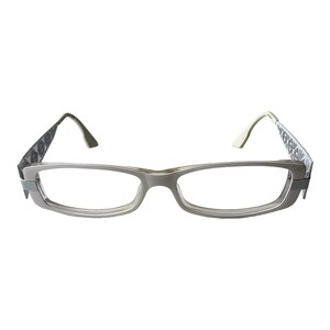 May include: Silver-toned rectangular eyeglasses with a black and white patterned design on the arms.