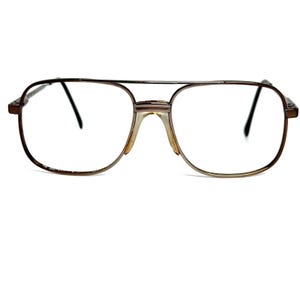 May include: Vintage aviator-style eyeglasses with a brown metal frame. The glasses have a double bridge and clear lenses. The earpieces and nose bridge show signs of wear. The overall design is classic and retro.