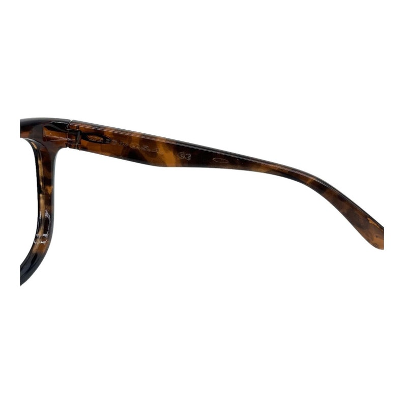 May include: Tortoise shell eyeglasses with a brown frame and a clear lens. The frame has the text "Oakley" and "O" on the side.