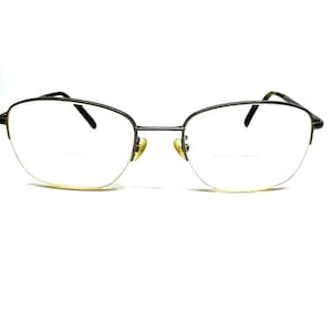 May include: A pair of black metal eyeglasses with a rectangular frame and clear lenses.