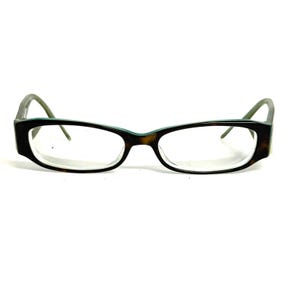 May include: Rectangular eyeglasses featuring a dark brown tortoiseshell pattern on the front frames and temples. The inner rim of the frames is accented with a thin, solid teal blue line. The clear lenses are held within a full-rim plastic structure.