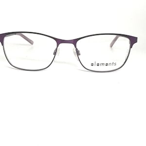 May include: Purple and black eyeglasses with a thin metal frame. The glasses have a rectangular shape with rounded edges. The brand name "elements" is printed on the right lens.
