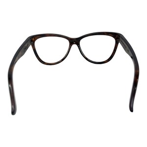 May include: Tortoise shell cat eye glasses with clear lenses.