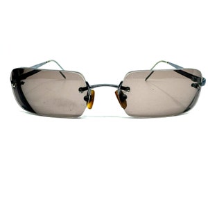May include: A pair of brown rectangular sunglasses with a thin metal frame.