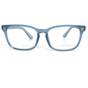 May include: Blue-tinted eyeglasses with a square frame. The glasses have a light blue frame and temples, and clear lenses. The design is a classic, everyday style.