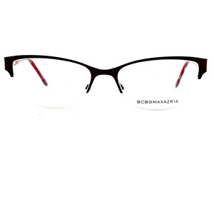 May include: Black cat-eye eyeglasses with a red accent on the inside of the frame. The brand name BCBGMAXAZRIA is printed on the right lens.