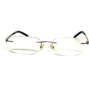 May include: Rimless spectacles featuring clear, oval-shaped lenses and a thin, dark metallic bridge. The frame includes slender, dark-coloured temples and adjustable yellow-toned nose pads, providing a lightweight and functional design for vision correction.