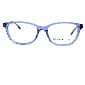 May include: Light blue eyeglasses with a cat-eye shape. The frames are a translucent, pale blue color. The brand name "BCBG MAX AZRIA" is printed on the right temple. The glasses have a modern, stylish design.