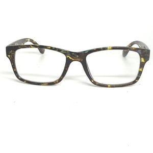 May include: Eyeglasses with a rectangular frame. The frame has a speckled pattern in shades of brown, yellow, and green. The lenses are clear. The arms of the glasses are also patterned.