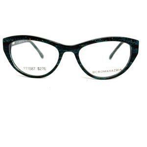 May include: Cat-eye style eyeglasses with a dark green speckled frame. The glasses have clear lenses and the text "111587 $276" is printed on the left lens. The brand name "BCBGMAXAZRIA" is printed on the right lens.