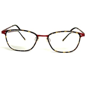 May include: Eyeglasses featuring a thin, vibrant red metal frame with a tortoiseshell pattern on the outer rims. The lenses are clear and oval-shaped, connected by a slim bridge, with thin, matching red metal temples extending from the sides.