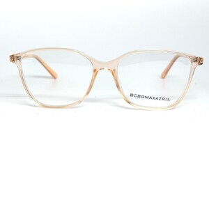May include: Clear eyeglasses with a light peach-colored frame. The glasses have a cat-eye shape and the brand name BCBGMAXAZRIA is printed on the lower right lens.