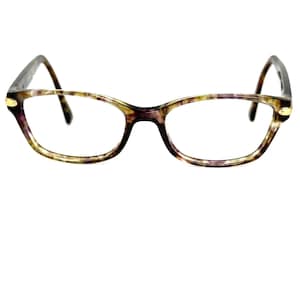 May include: Eyeglasses with a patterned frame in shades of purple, brown, and yellow. The glasses have a rectangular shape with rounded edges and dark temples. The frame is accented with gold-colored details.