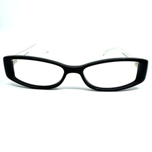 May include: Black plastic framed eyeglasses with a clear lens.