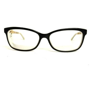 May include: A pair of eyeglasses featuring a glossy black plastic frame with a rounded rectangular shape. The temples are a contrasting light beige color, visible at the hinges. The lenses are clear and transparent, set within the dark rims.