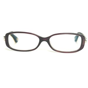 May include: A pair of eyeglasses with a dark purple frame and clear lenses. The rectangular frames have rounded edges and are set against a white background. The temples are a dark green color.