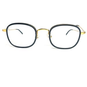 May include: Black and gold rectangular eyeglasses with a thin metal frame.