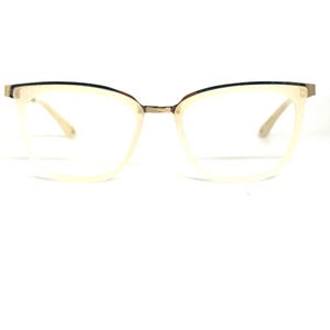 May include: Ivory-colored eyeglasses with a gold-tone bridge and temples. The frames have a subtle cat-eye shape. The lenses are clear. The glasses are set against a white background.