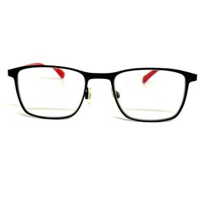 May include: A pair of eyeglasses featuring a thin black rectangular frame with clear lenses. The inner side of the temple arms is a vibrant red color. The glasses include adjustable metallic nose pads attached to the bridge of the frame.