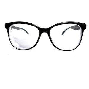 May include: Black-framed eyeglasses with clear lenses. The glasses have a rounded, slightly cat-eye shape. The frames are thick and solid, with a glossy finish. The temples are thin and curve gently to fit behind the ears. The lenses are clear and free of any visible markings.