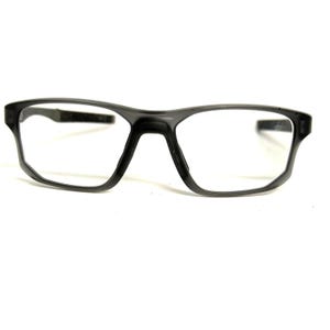 May include: A pair of rectangular eyeglasses with a translucent dark gray frame. The glasses feature a bridge, two clear lenses, and two side arms that extend outward. The design is simple and functional, with a smooth finish on the plastic material.