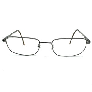 May include: A pair of silver-toned metal eyeglasses with a rectangular frame.