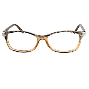 May include: Brown and silver eyeglasses with a striped pattern on the frame.