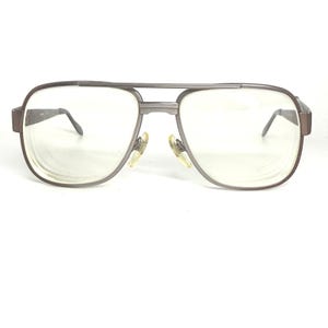 May include: Vintage aviator eyeglasses with a silver-grey metal frame. The clear lenses are set in a double bridge design. The nose pads are light yellow, and the temples are straight.