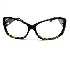 May include: A pair of tortoise shell eyeglasses with a cat-eye shape.
