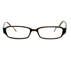 May include: Brown rectangular eyeglasses with a light brown interior frame and temples. The glasses have a classic design and are set against a white background.