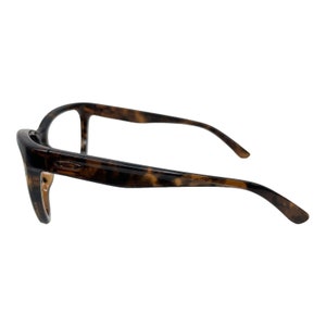 May include: Tortoise shell eyeglasses with a brown frame.
