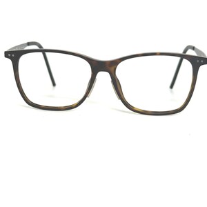 May include: Eyeglasses with a tortoiseshell pattern frame and black temples. The rectangular lenses are clear. The glasses are designed for vision correction and are suitable for everyday use.