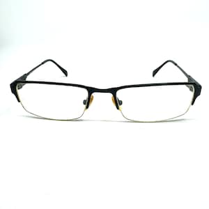 May include: Black half-rim spectacles with a rectangular frame.