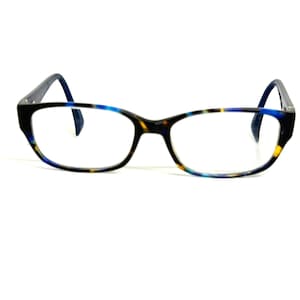 May include: Eyeglasses with a rectangular frame featuring a multi-colored pattern of blue, black, and yellow tortoise shell. The frame has thin, dark blue temples that curve at the ends. The lenses are clear and the bridge connects the two rims.
