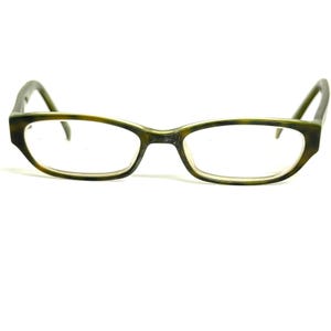 May include: A pair of eyeglasses featuring a rectangular frame with a mottled green and brown tortoiseshell pattern. The glasses have clear lenses and thin, curved temples that extend from the outer corners of the frame to rest on the ears.