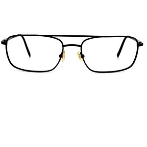 May include: Black metal-framed eyeglasses with a rectangular shape. The glasses have a double bridge and clear lenses. The nose pads are a light tan color. The overall design is a classic, vintage style.