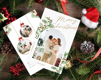 May include: Two Christmas card designs featuring a family photo and the text "Merry Christmas". The cards have a watercolor background with green leaves and red berries.