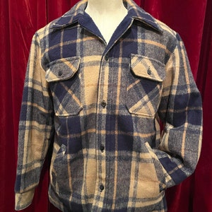 May include: A blue and tan plaid flannel shirt with a button-up front and long sleeves.
