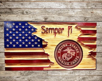 May include: A wooden American flag with a distressed look, featuring the United States Marine Corps emblem and the words "Semper Fi".