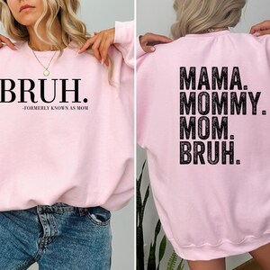 May include: Pink sweatshirt with the text "BRUH." on the front and "MAMA. MOMMY. MOM. BRUH." on the back.