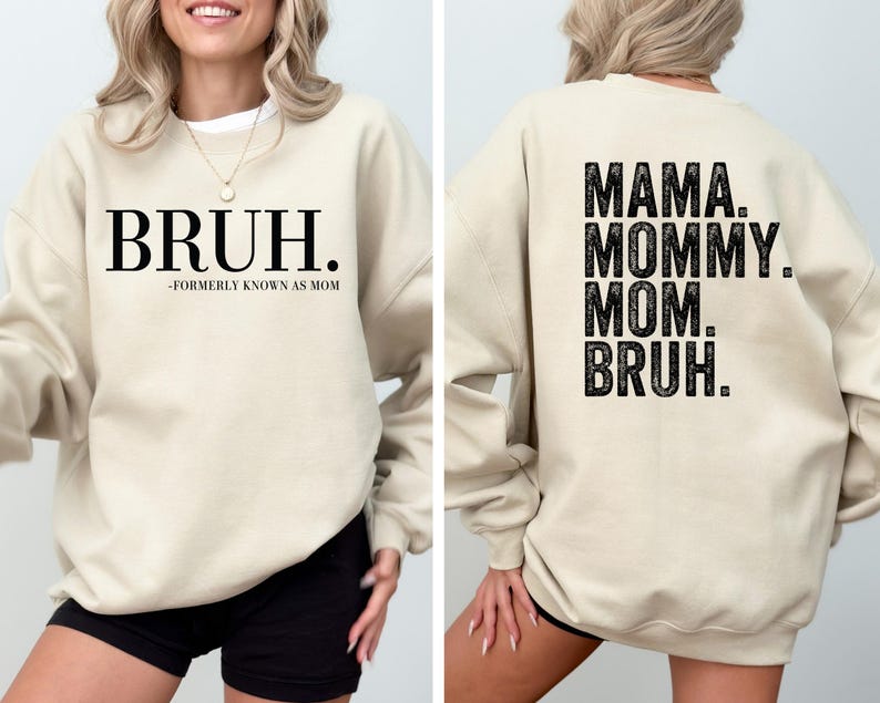 May include: A beige sweatshirt with black text. The front of the sweatshirt says "BRUH. -FORMERLY KNOWN AS MOM". The back of the sweatshirt says "MAMA. MOMMY. MOM. BRUH."